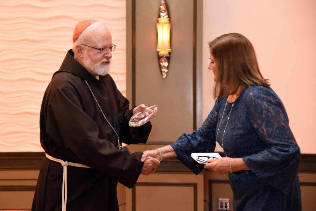 Cardinal Sean handing out an award